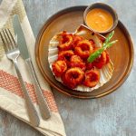 Squid dish on a plate made by Potyo Indian restaurant